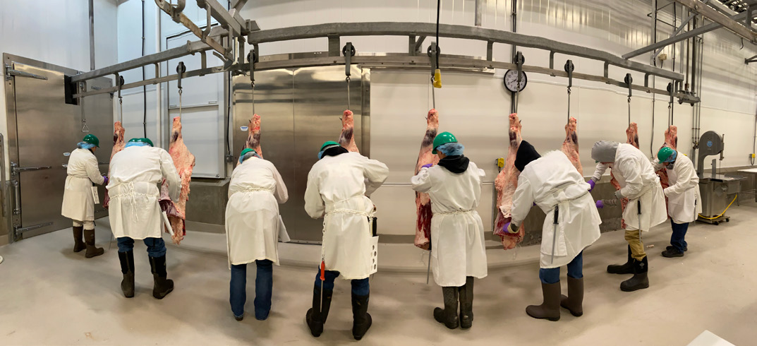 Participants practicing cutting meat.